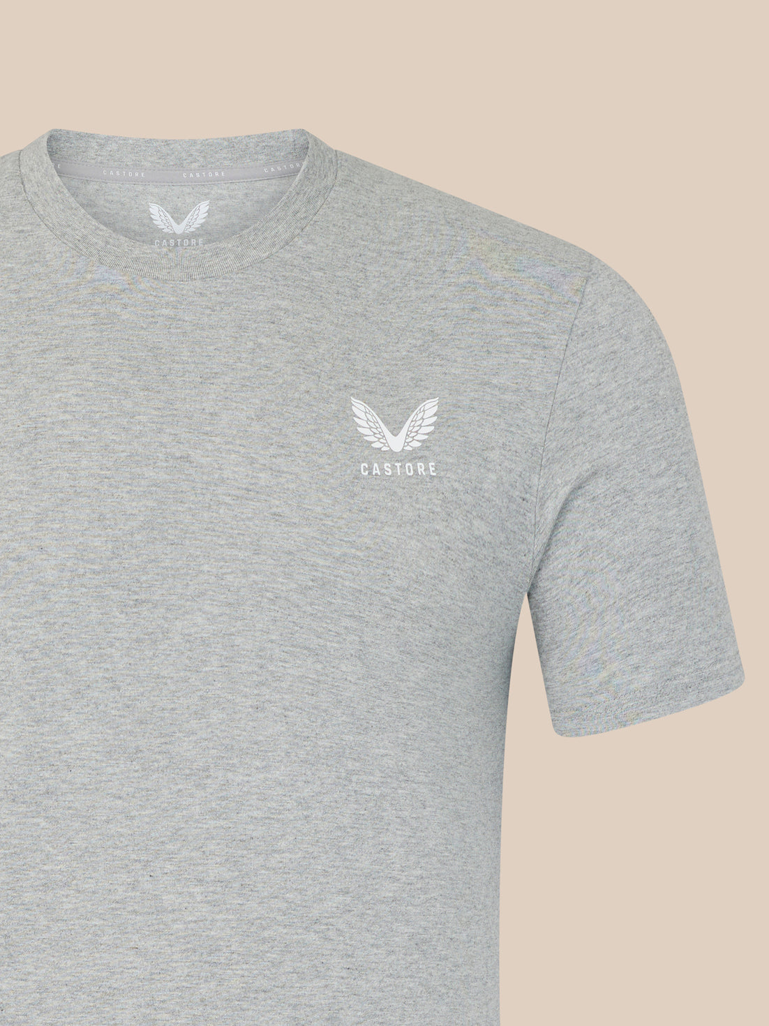 Gray t-shirt with a white logo on a beige background