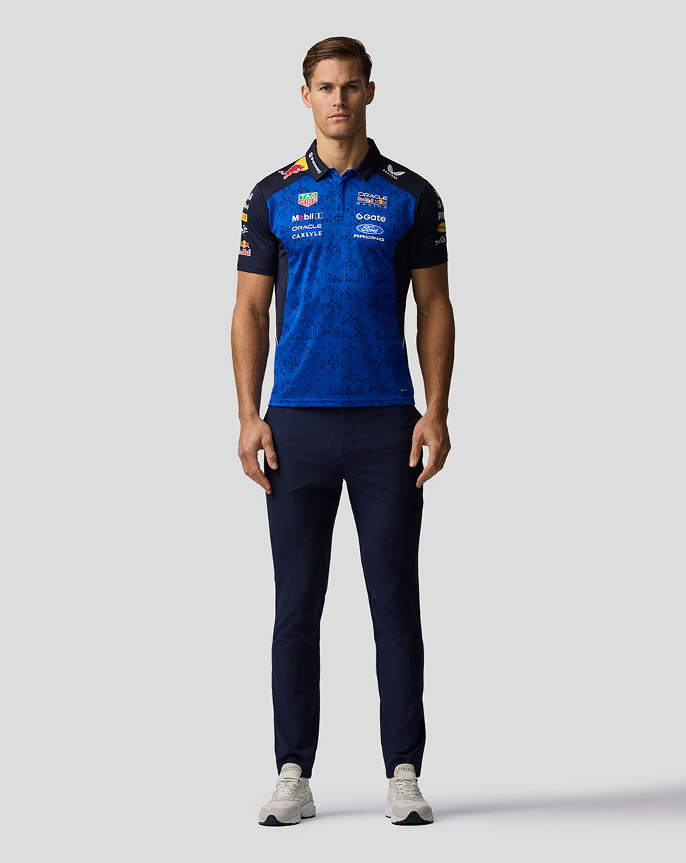 Man wearing a blue and black sports outfit with visible branding on a light gray background