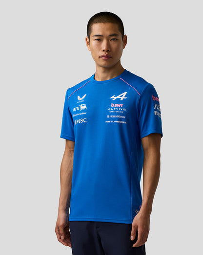 Person wearing a blue sports jersey with various logos on a white background
