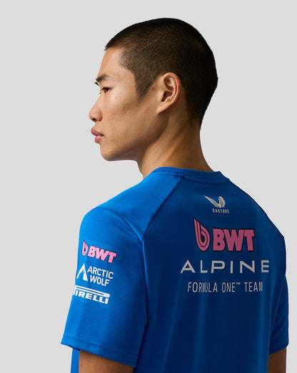 Person wearing a blue Formula One team shirt with visible branding on a gray background