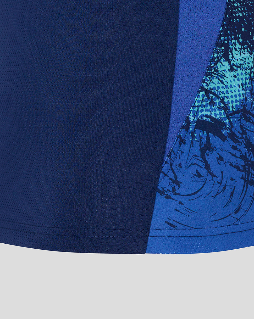 Close-up of a blue athletic shirt with a graphic design on a light gray background