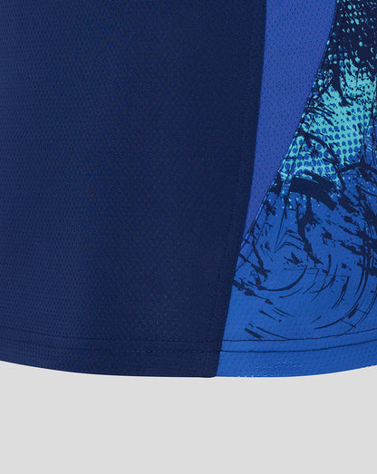 Close-up of a blue athletic shirt with a graphic design on a light gray background