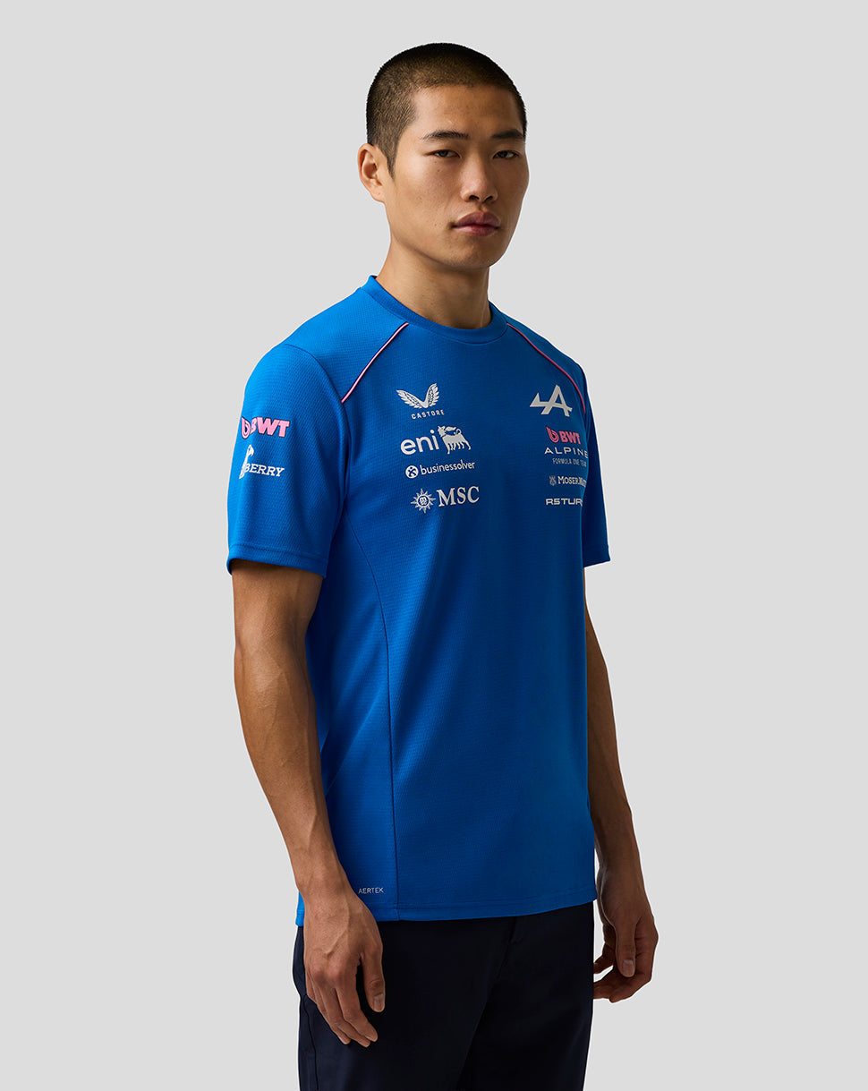 Man wearing a bright blue BWT Alpine Formula One Team Set Up shirt with sponsor logos.