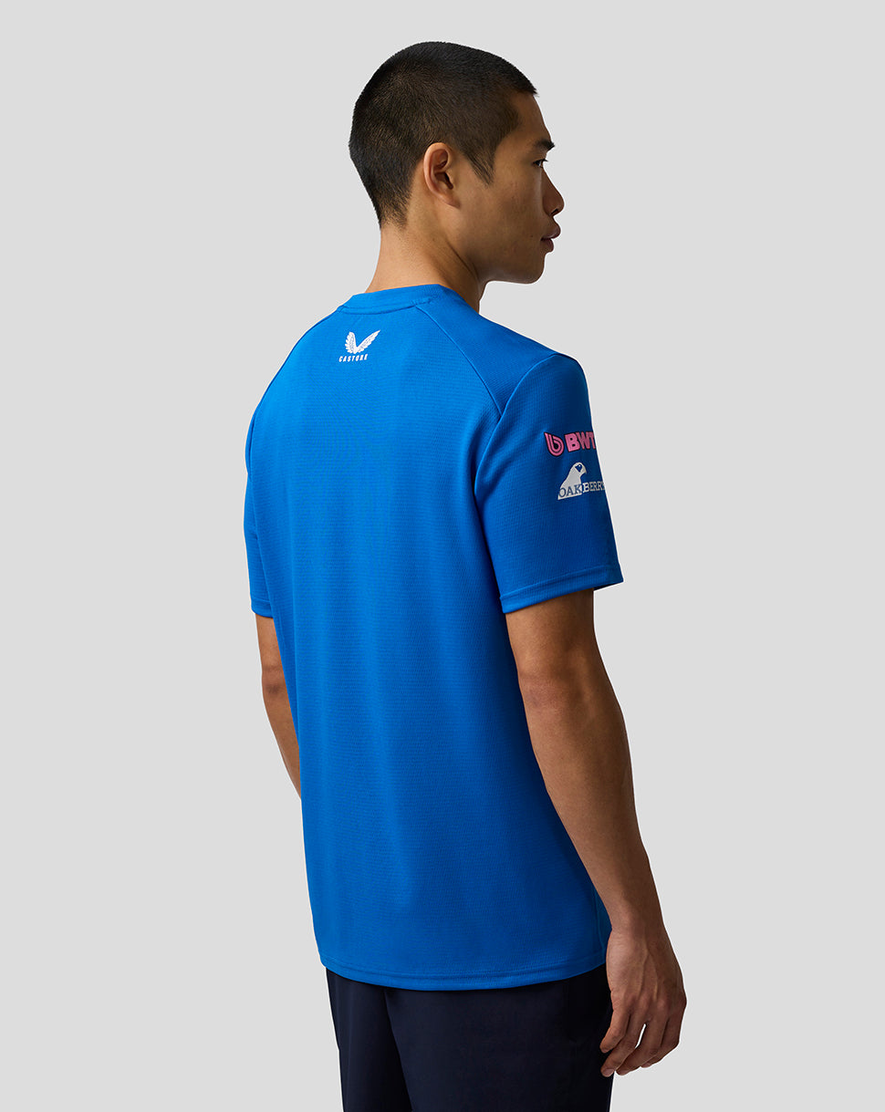 Back view of a blue BWT Alpine Formula One Team Set Up shirt on a model with a small white logo at the upper back.