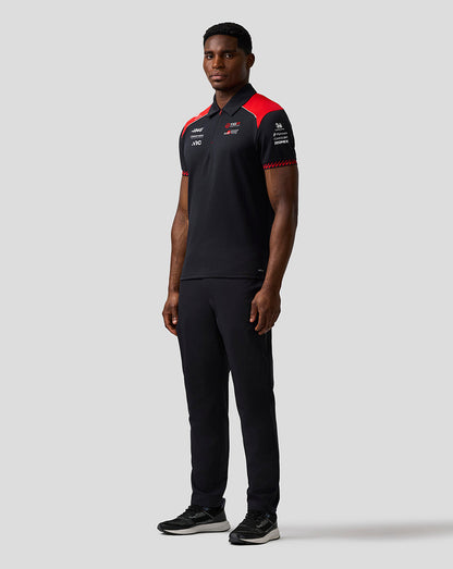 Person wearing a black and red sports outfit on a white background