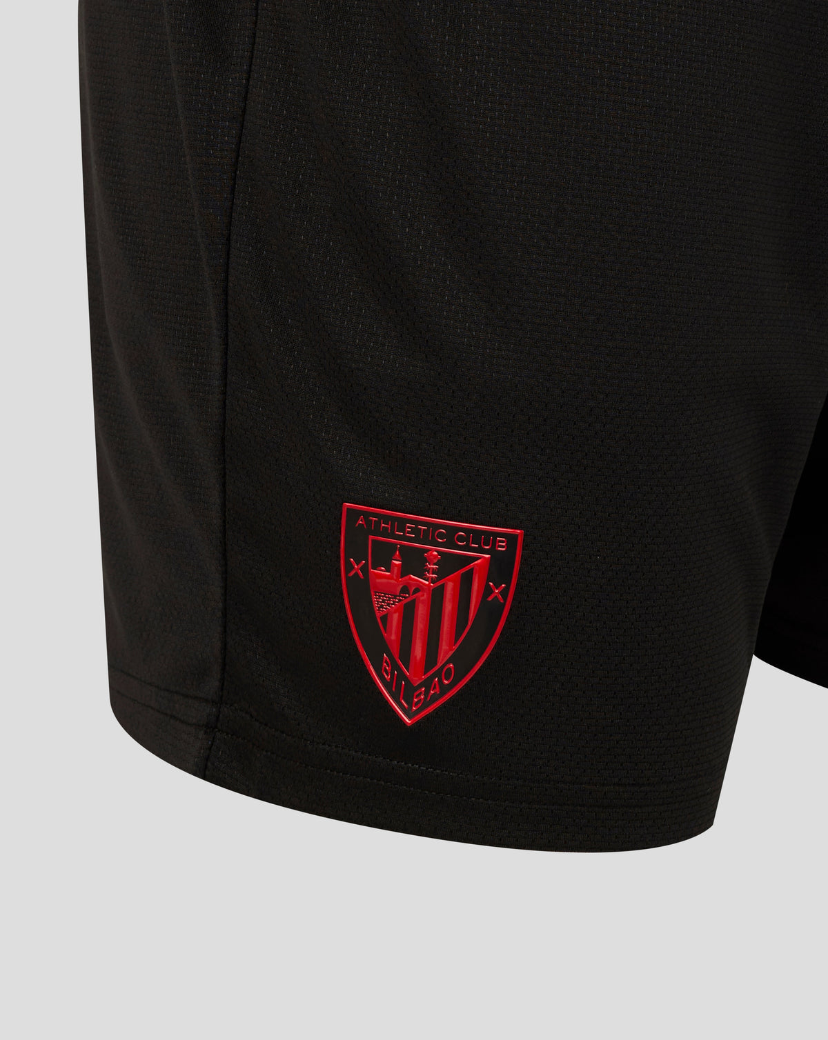 Front view of black shorts with light blue side panels, zip pockets, club crest on left leg and Castore logo on right.
