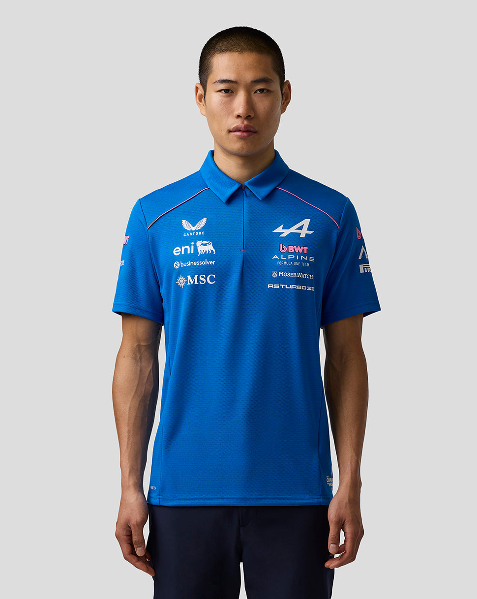 A male model wearing a bright blue short-sleeve polo shirt with various white and red sponsor logos, including Eni, MSC, and D.B.