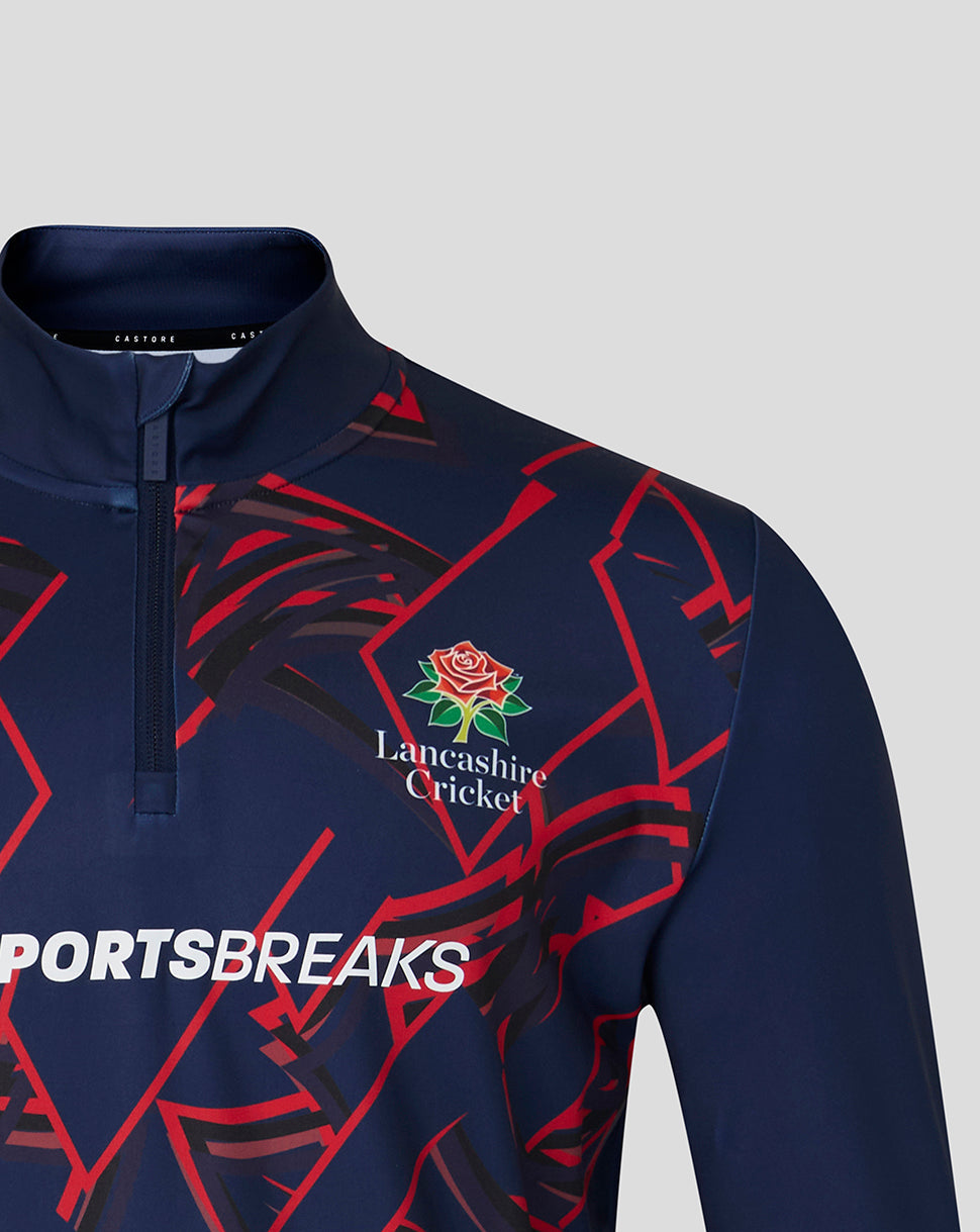 Navy sports shirt with red geometric patterns and Lancashire Cricket logo on a gray background