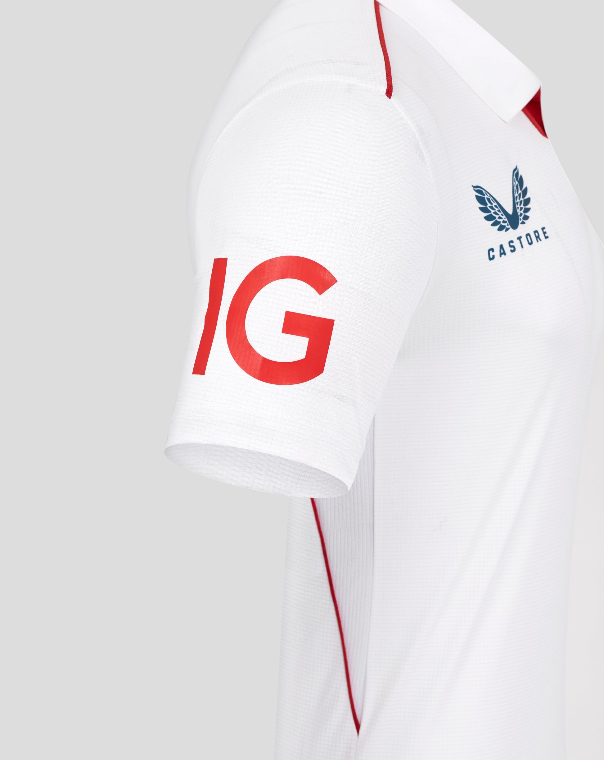 White sports jersey with red and blue branding on a light gray background