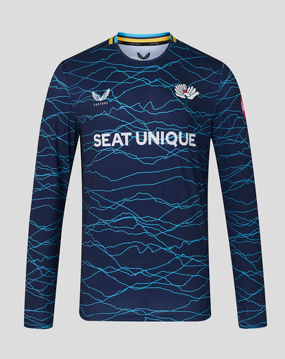 Navy long-sleeve sports jersey with blue wave pattern and visible branding on a gray background