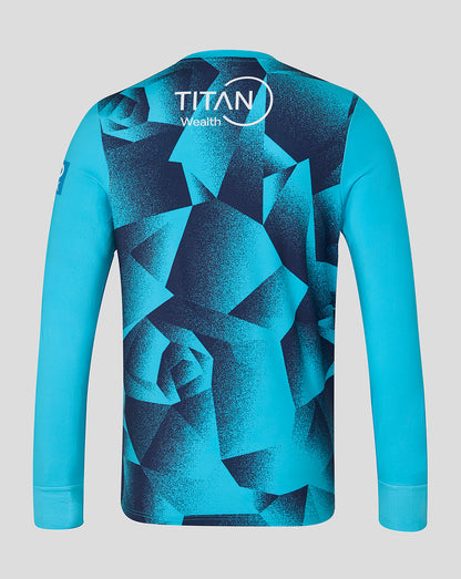 Blue long-sleeve shirt with geometric pattern and Titan Wealth logo on a gray background