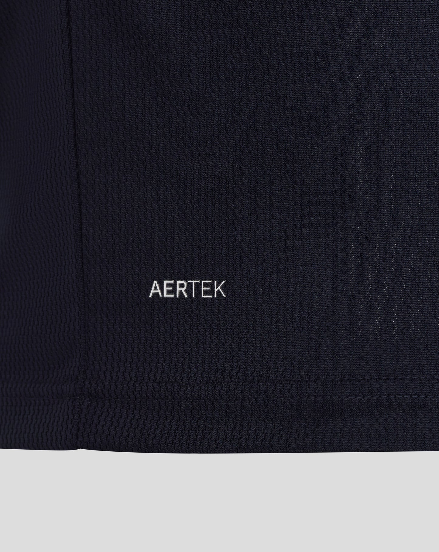 Close-up of a black fabric with 'AERTEK' logo on a white background