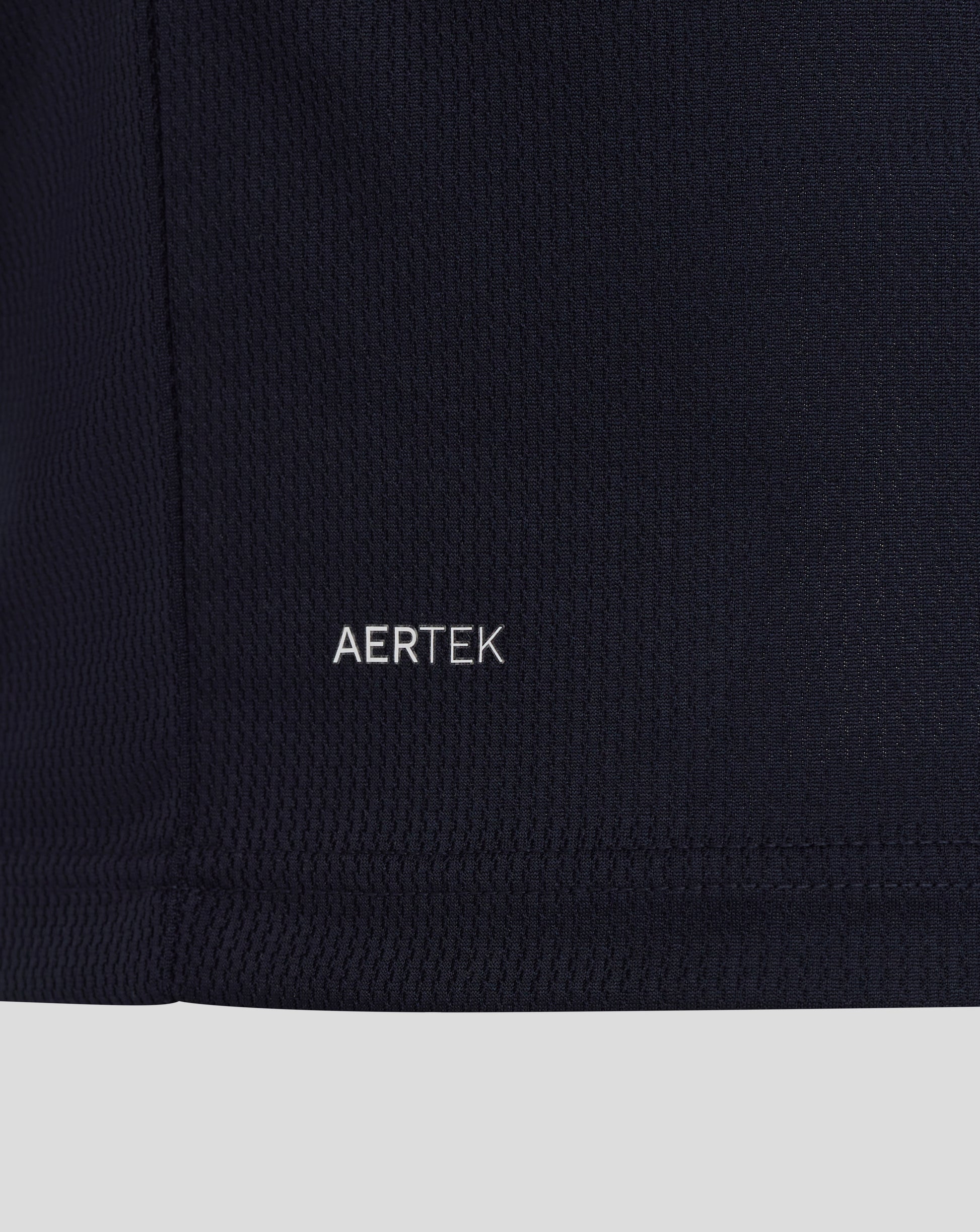 Close-up of a black fabric with 'AERTEK' logo on a white background