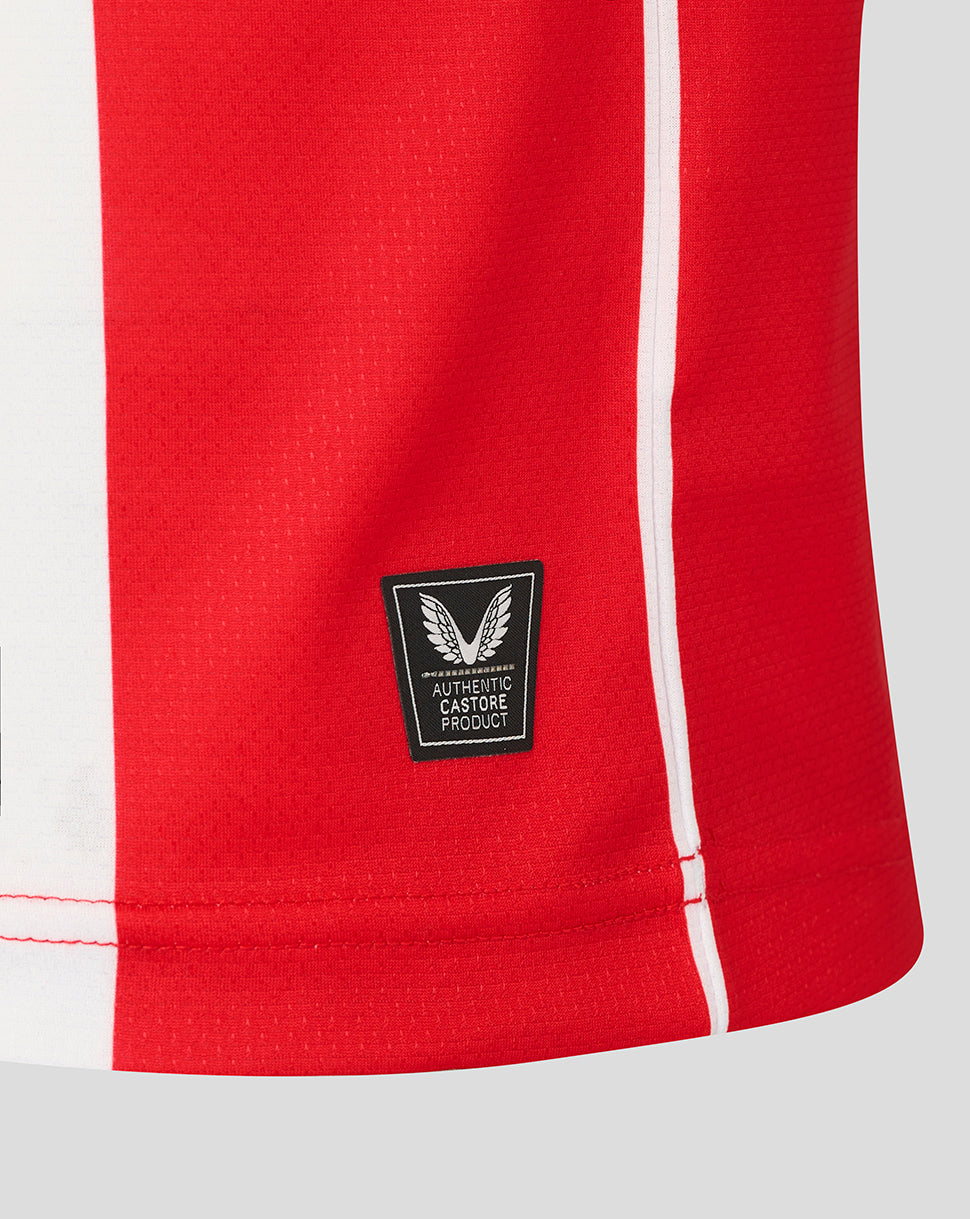 Hem view of the Athletic Club retro jersey with an authentic Castore product patch and red side stripe