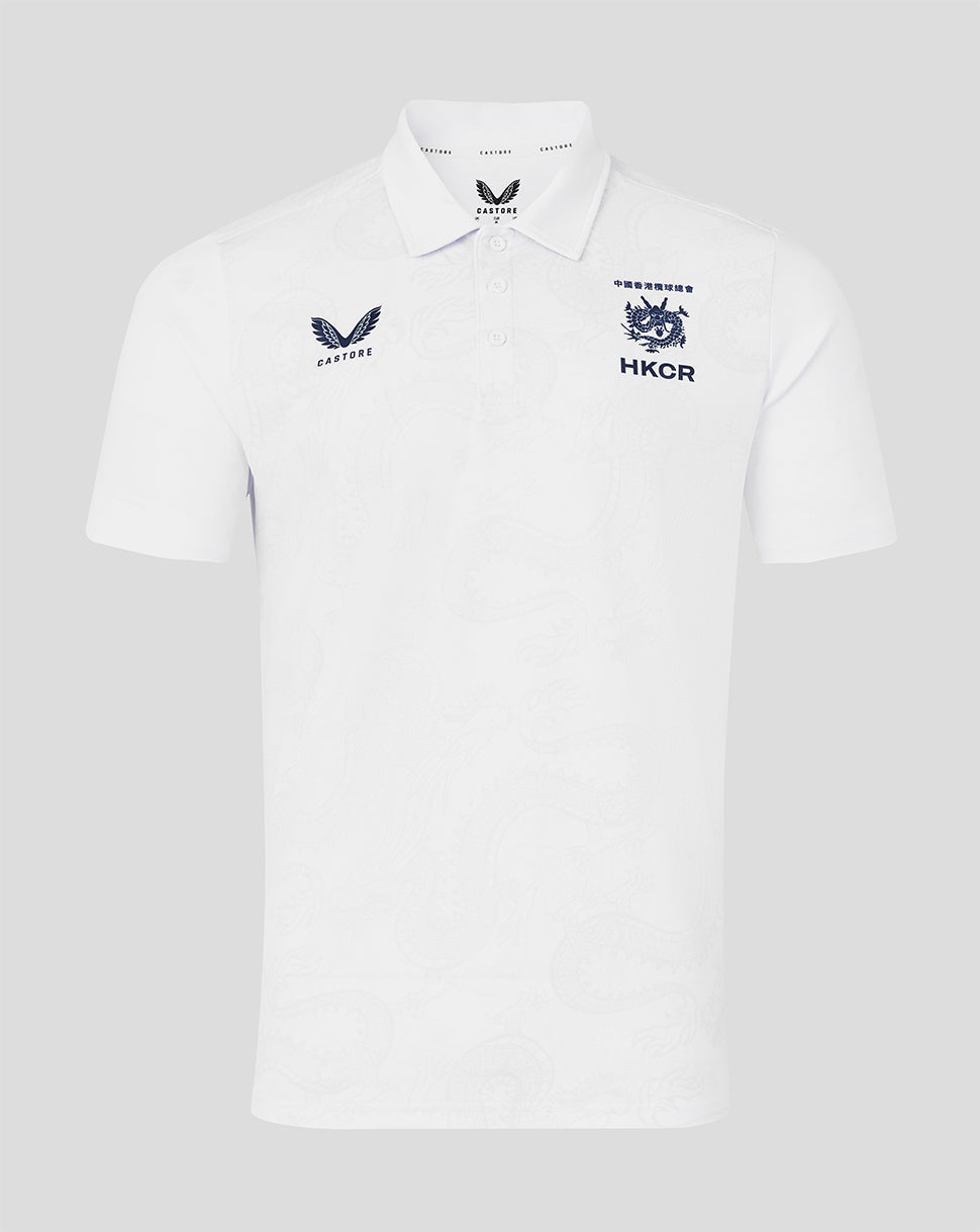 White polo shirt with embroidered logos on a light gray background