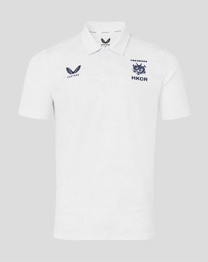White polo shirt with embroidered logos on a light gray background