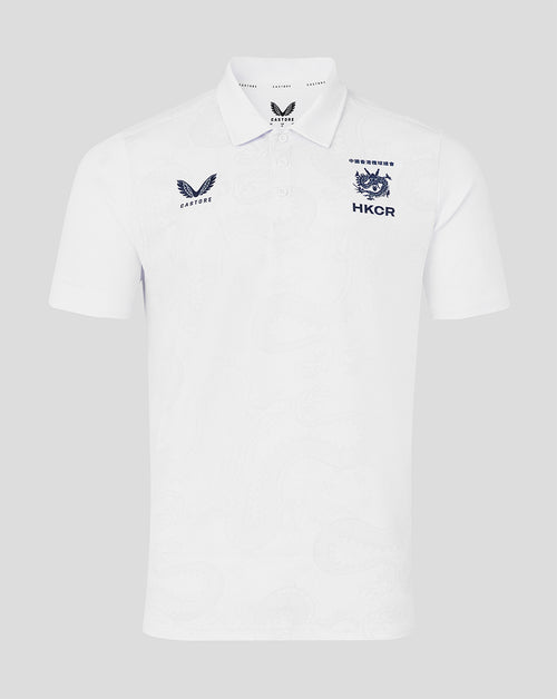 White polo shirt with embroidered logos on a light gray background