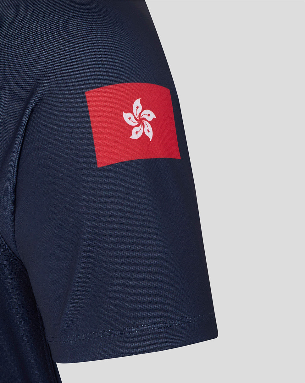 Navy blue shirt with a red and white emblem on the sleeve against a light gray background