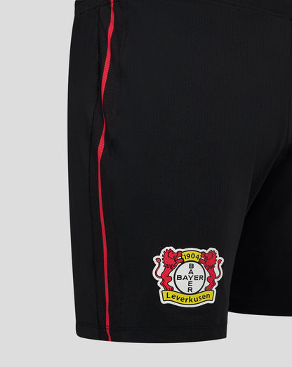 Front lower leg of black shorts showing the Bayer Leverkusen crest badge on the thigh area