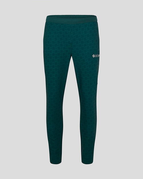 Green men's Athletic Club travel pants with a subtle jacquard pattern and a logo on the right thigh.
