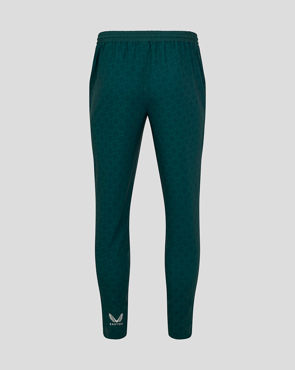 Back view of green patterned travel pants with elastic waistband and Castore logo at the ankle.