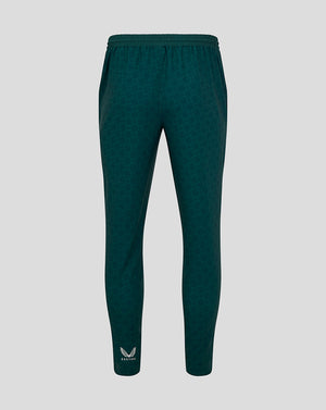 Back view of green patterned travel pants with elastic waistband and Castore logo at the ankle.