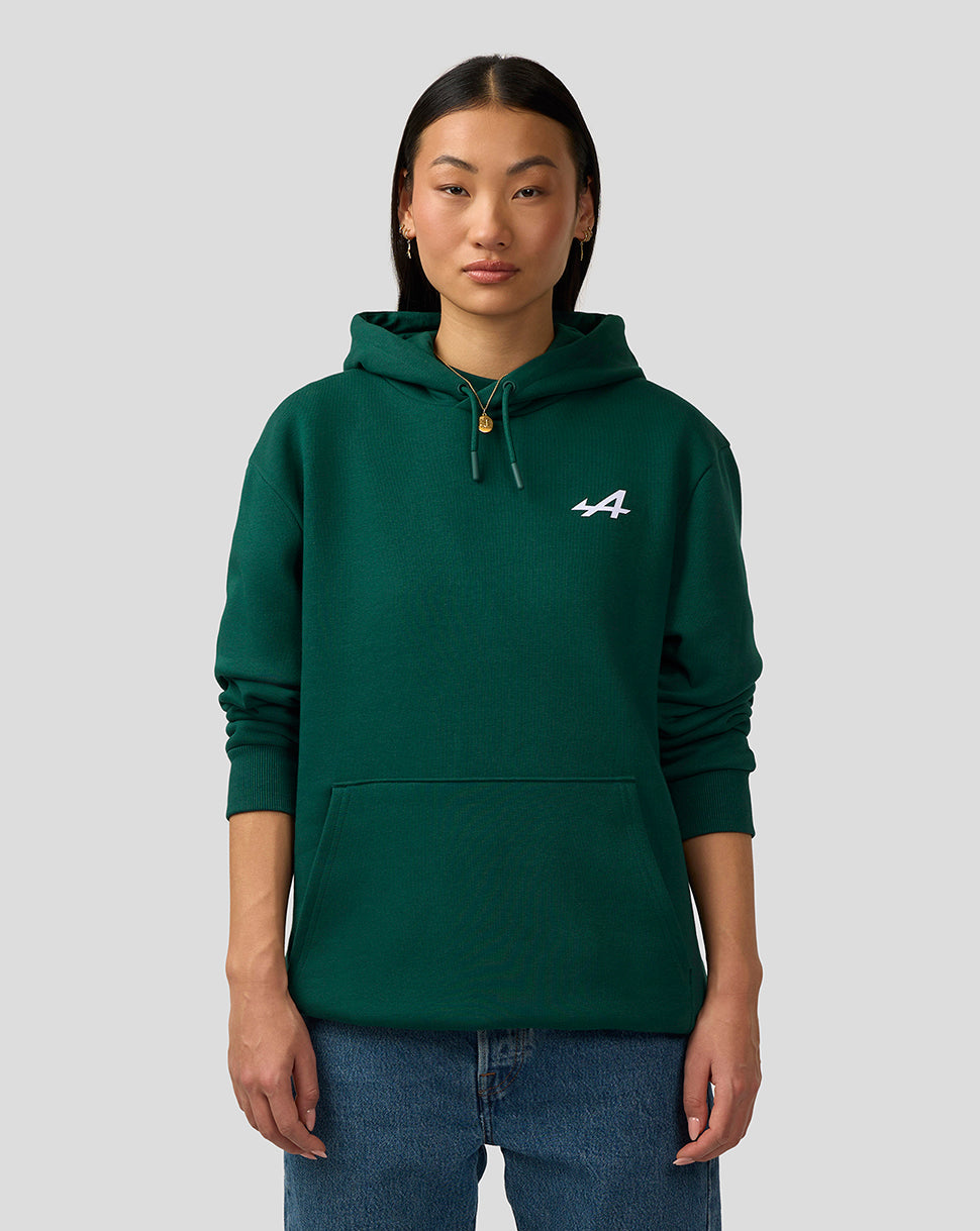 Front view of a person wearing a forest green Alpine hoodie with a white chest logo and a front pocket