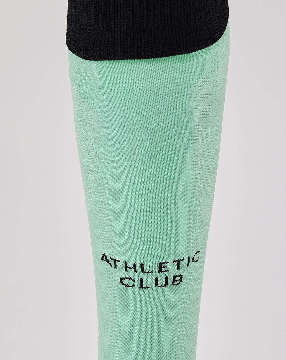 Close up of mint green Athletic Club Adult 25/26 Third Sock showing shin branding.