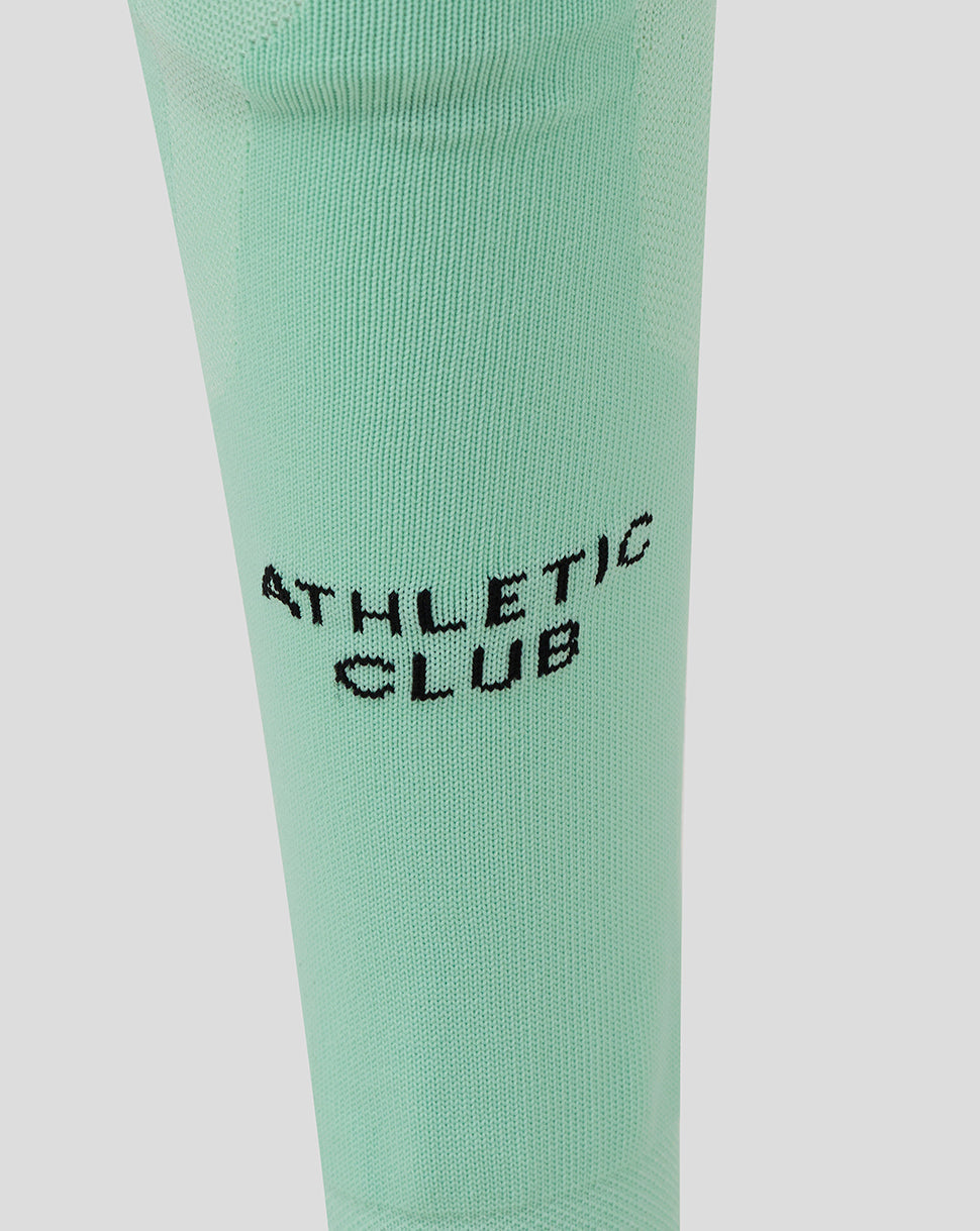 Mint green Athletic Club sock close-up showing calf branding.
