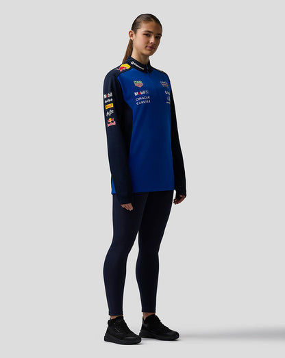 Person wearing a blue and black outfit with visible branding on a white background