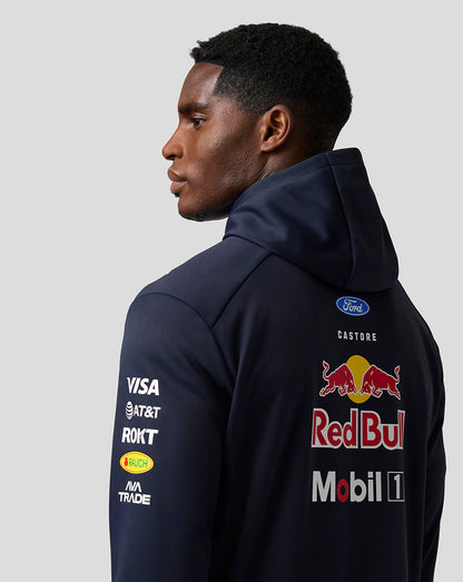 Person wearing a navy hoodie with Red Bull and Ford logos on a gray background
