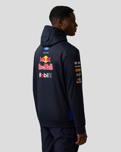 Person wearing a navy hoodie with Red Bull and Mobil 1 logos on the back against a white background