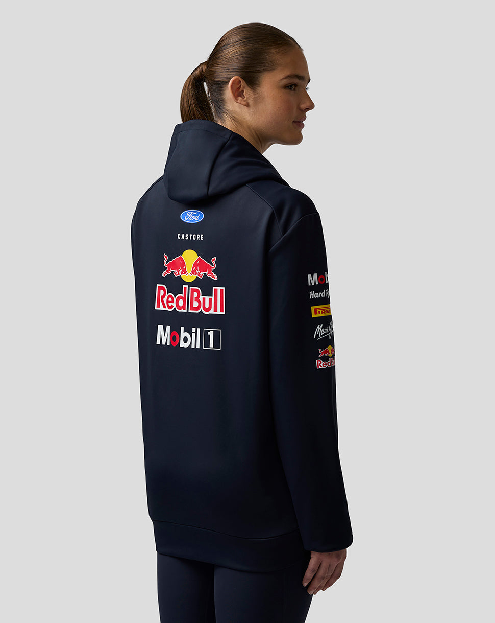 Person wearing a navy hoodie with Red Bull and Mobil 1 logos on the back, on a light gray background