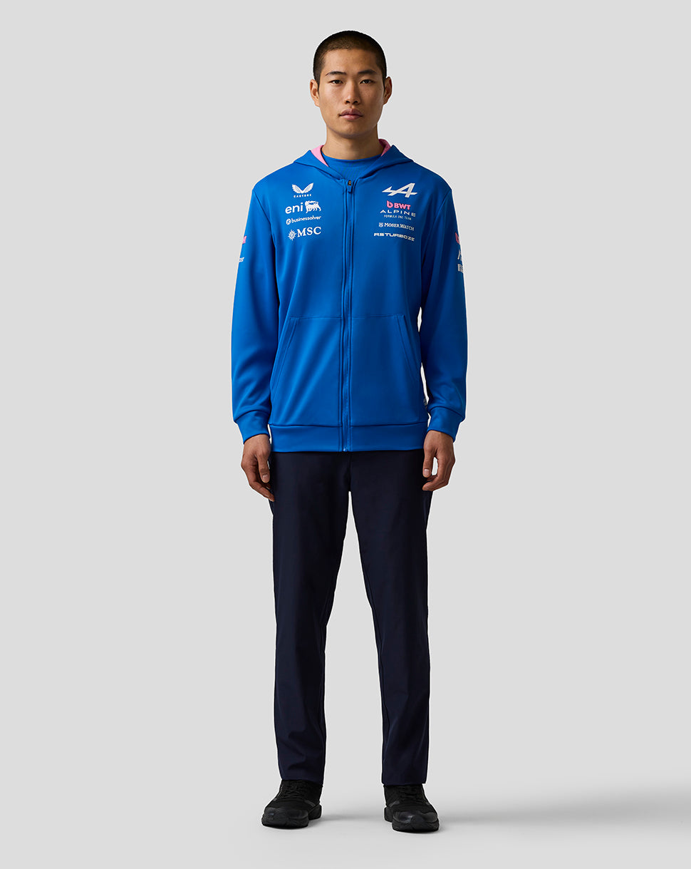 Front view of blue Official Junior BWT Alpine Formula One Team zip hoodie on a model with chest and sleeve sponsor logos.