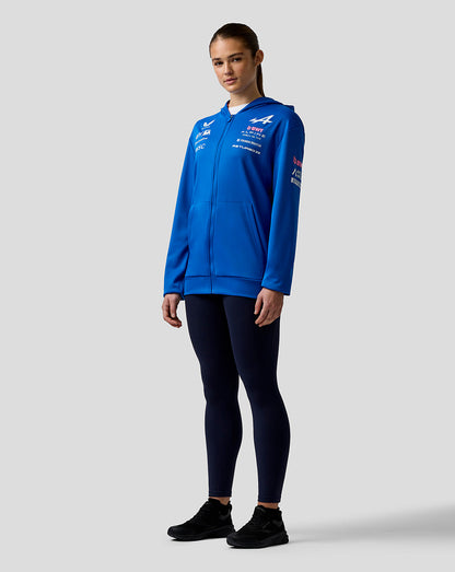 Front view of blue Official Junior BWT Alpine Formula One Team zip hoodie worn by a standing model with chest logos.