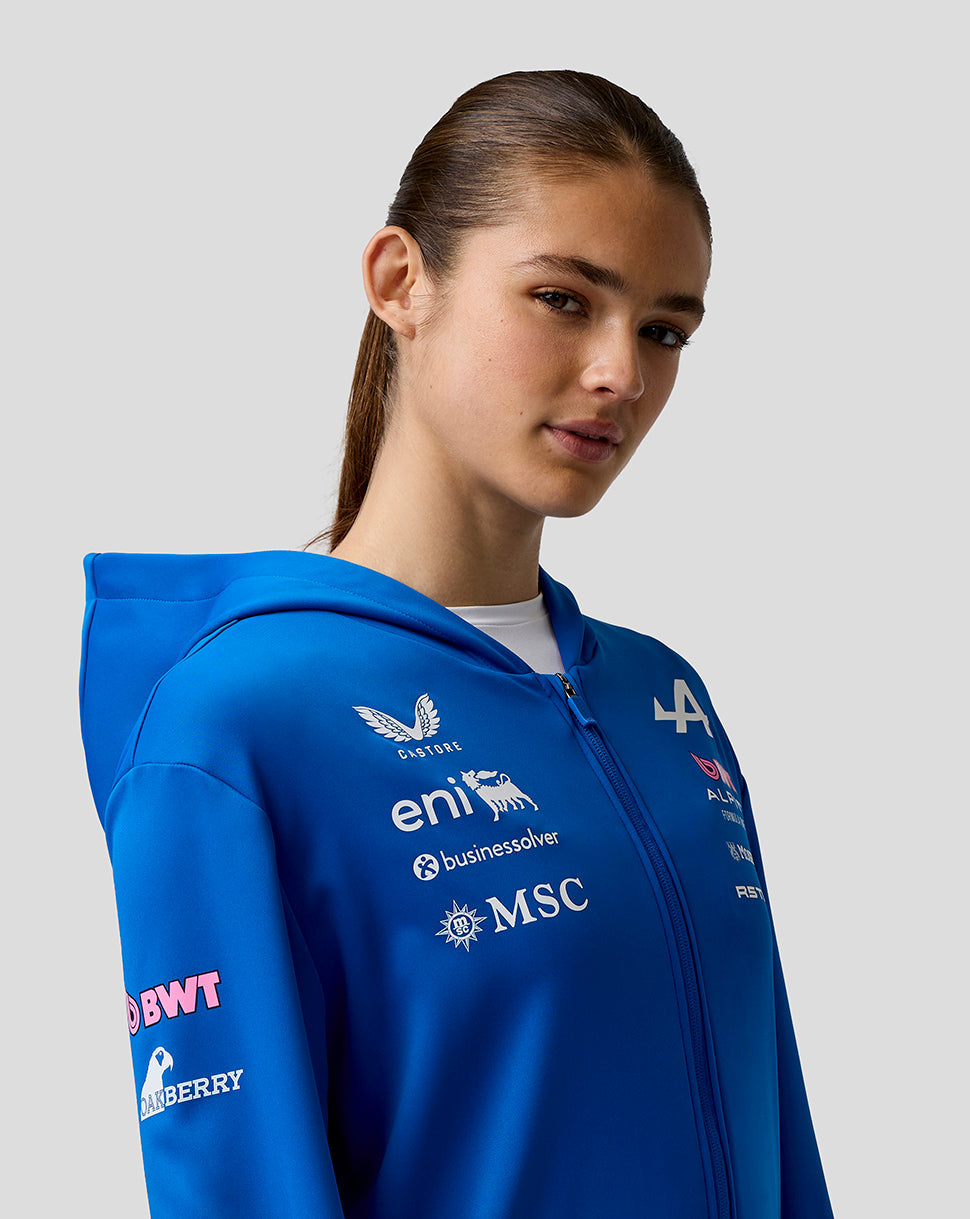 Profile view of a model wearing the Official Junior BWT Alpine Zip Hoodie in blue with chest logos