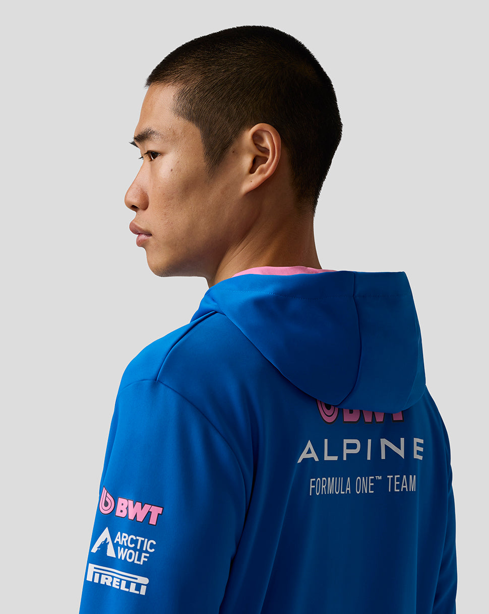 Back view of bright blue BWT Alpine zip hoodie on a model with Alpine branding on the back and logos on the sleeve