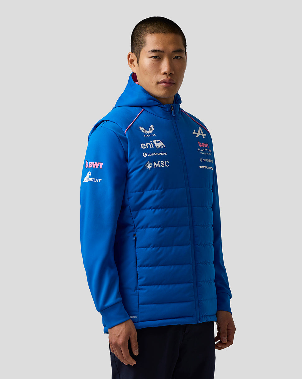 Blue BWT Alpine Formula One Team gilet worn by a female model with prominent chest logos and quilted panels