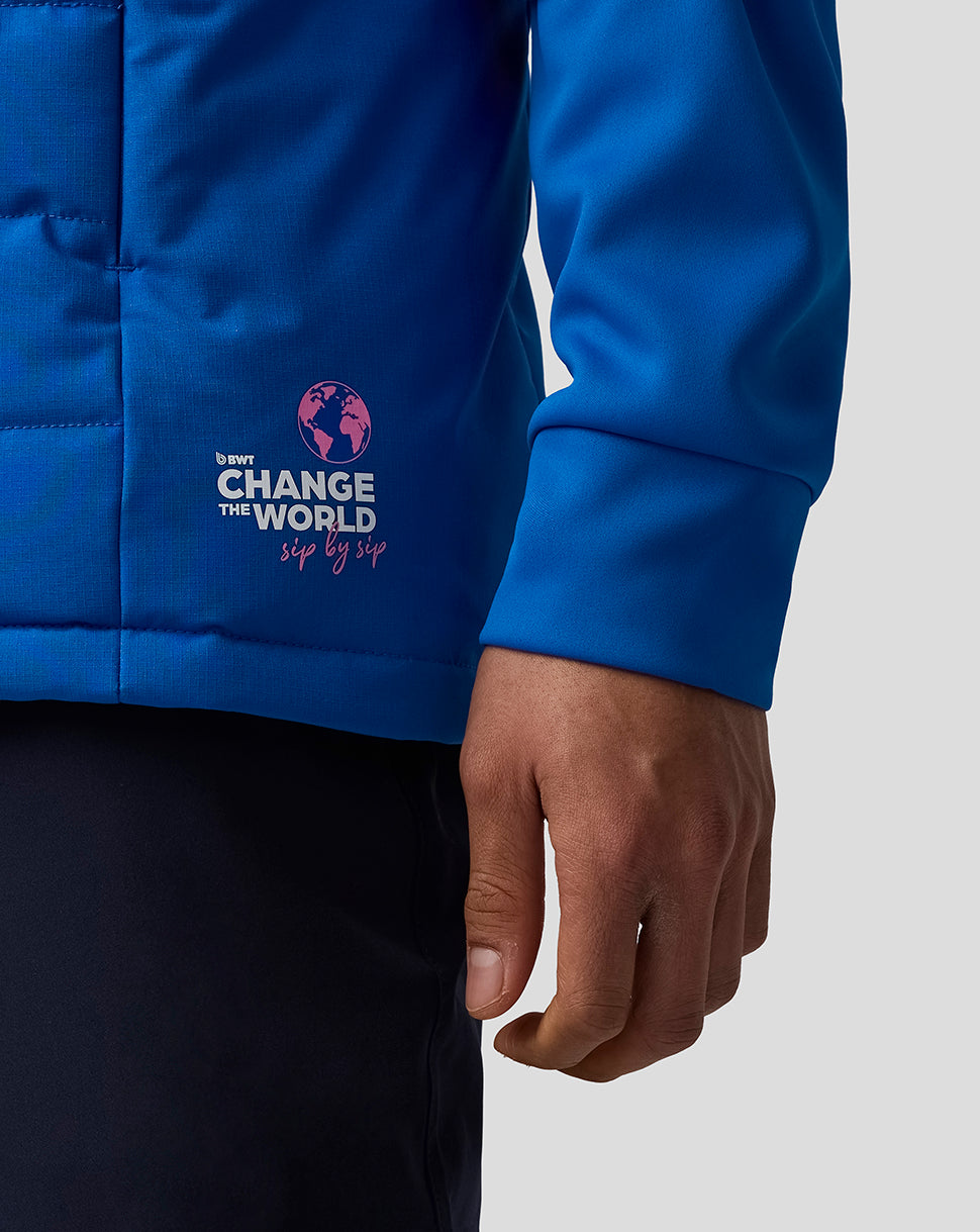 Blue BWT Alpine unisex gilet close-up showing the Change the World logo on the lower front panel and a zip side pocket.