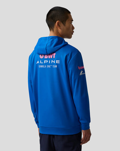 Person wearing a blue hoodie with Formula One branding on a gray background