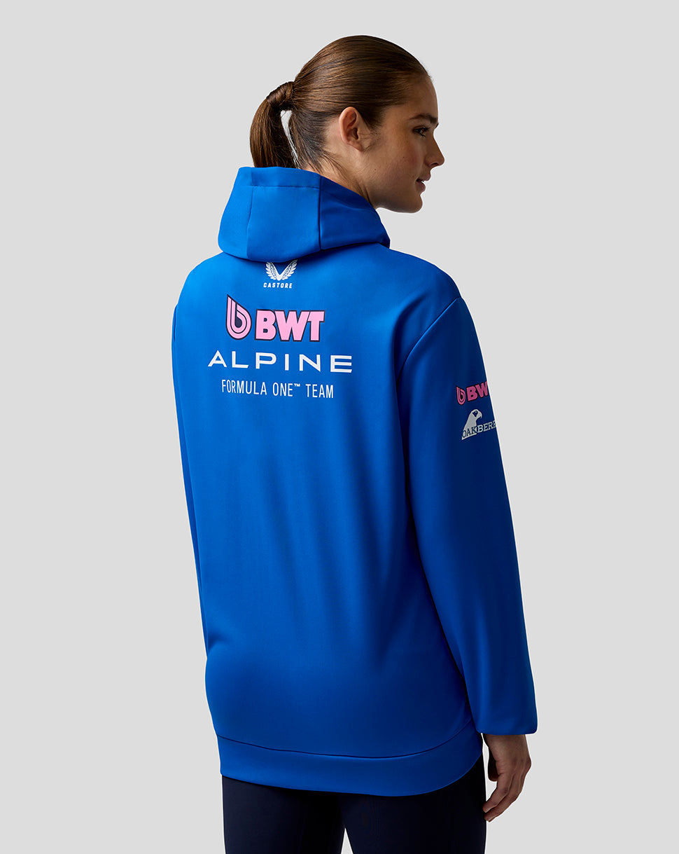 Person wearing a blue hoodie with BWT Alpine Formula One Team logos on a gray background