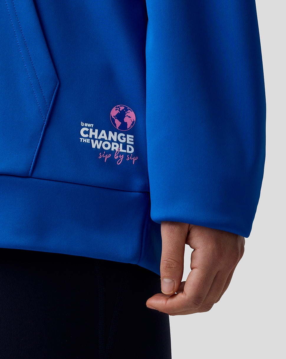 Blue jacket with a logo and text on the sleeve, against a neutral background.
