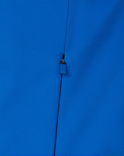 Detail of the center front zipper with blue pull on the blue soft shell jacket.