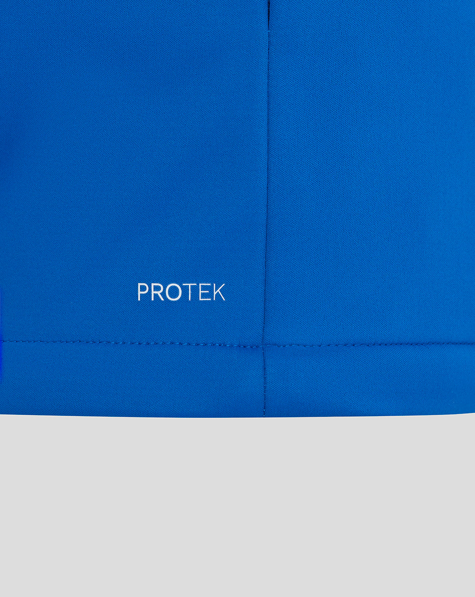 Blue jacket fabric close up with PROTEK wordmark near the hem