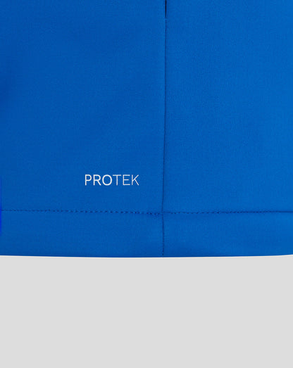 Blue jacket fabric close up with PROTEK wordmark near the hem