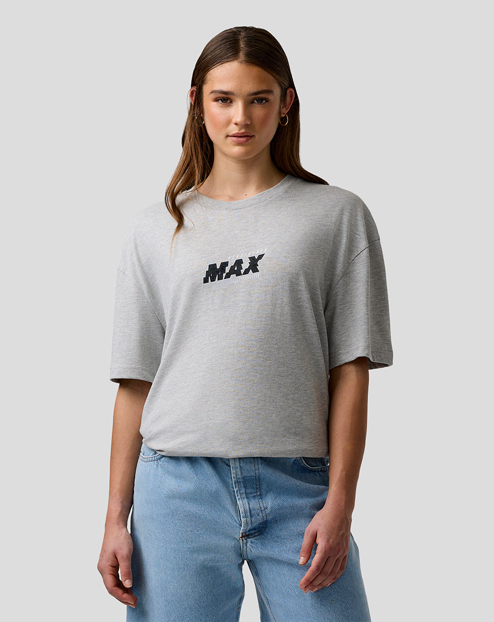 Person wearing a gray t-shirt with 'MAX' print and blue jeans on a light gray background