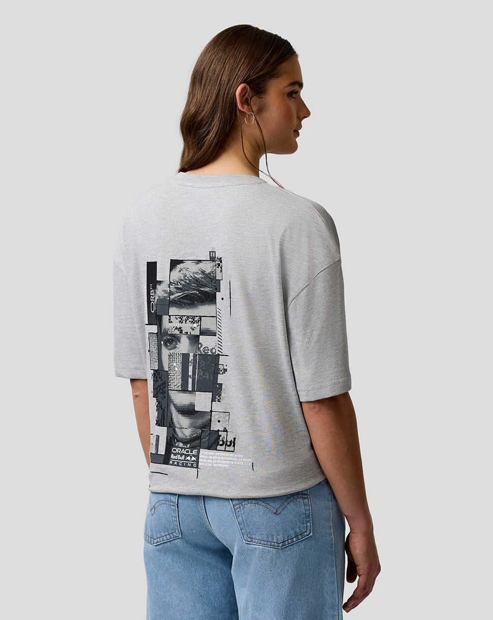 Person wearing a gray t-shirt with a graphic design on the back, standing against a plain background