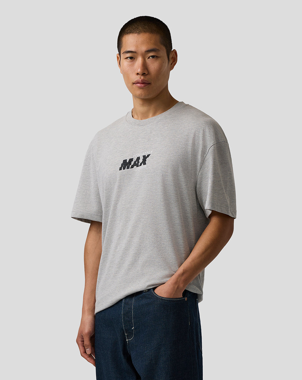 Man wearing a gray t-shirt with 'MAX' logo on a plain background