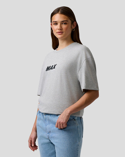 Person wearing a gray t-shirt with 'MAX' text and light blue jeans on a plain background