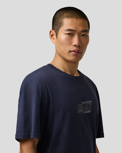 Man wearing a navy blue t-shirt with a logo on a light gray background